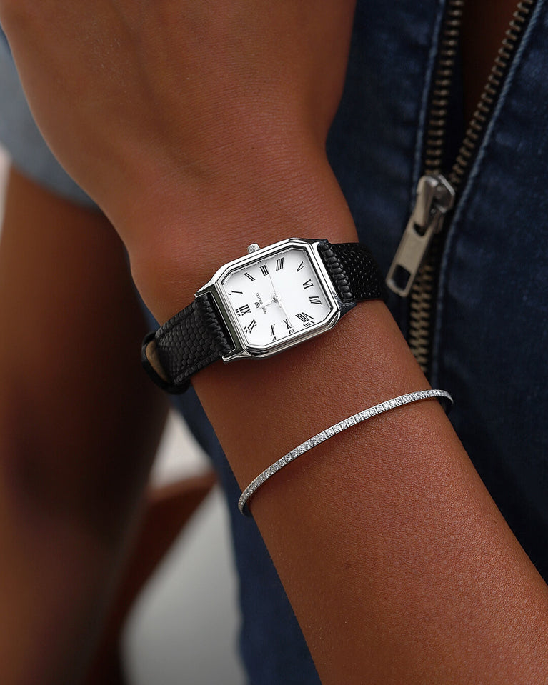 A square womens watch in Rhodium-plated 316L stainless steel from Waldor & Co. with white Diamond Cut Sapphire Crystal glass dial. Strap in black Genuine leather. Seiko movement. The model is Eternal 22 Varenna.