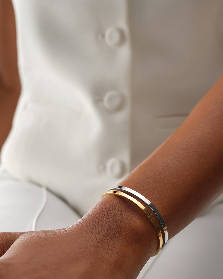 A Bangle in 14k gold plated 316L stainless steel from Waldor & Co. One size. The model is Dual Bangle Polished.