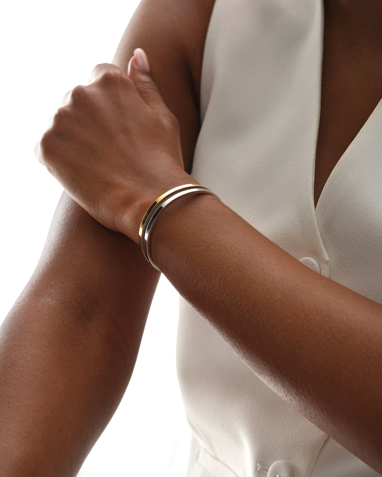 A Bangle in 14k gold plated 316L stainless steel from Waldor & Co. One size. The model is Dual Bangle Polished.