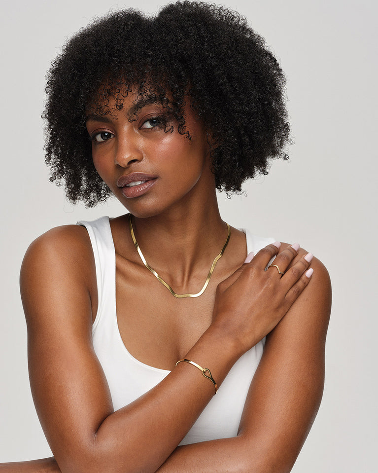 A Ring in polished 14k gold plated 316L stainless steel from Waldor & Co. The model is Chloé Ring Polished.'