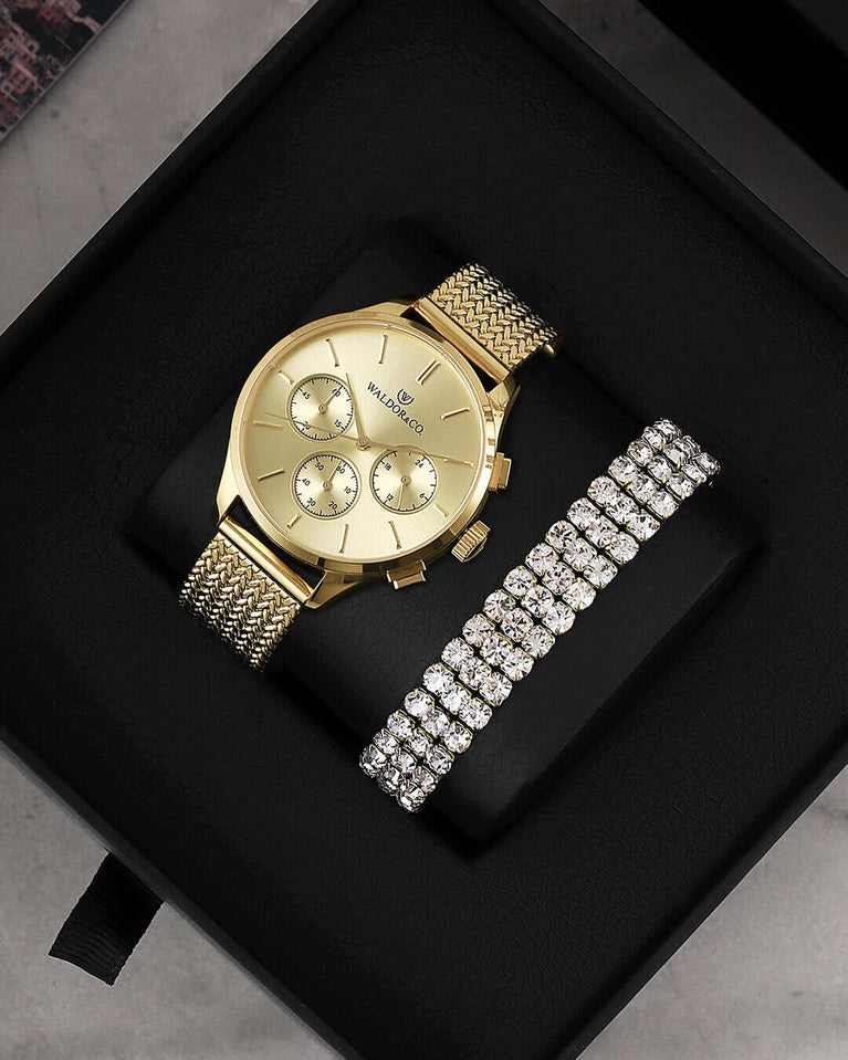 A round womens watch in 22k gold from Waldor & Co. with gold sunray dial and a second hand. Seiko movement. The model is Epoch 36 Formentera 36mm.