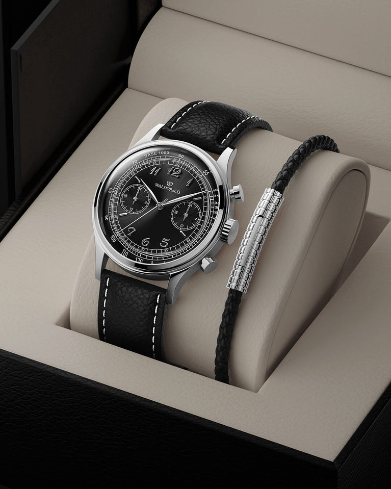  A round mens watch in Rhodium-plated 316L stainless from Waldor & Co. with black sunray dial. Curved mineral glass with 5 layers anti-reflective coating. Seiko VD32 movement. Genuine leather strap. The model is Avant 39 Eze.